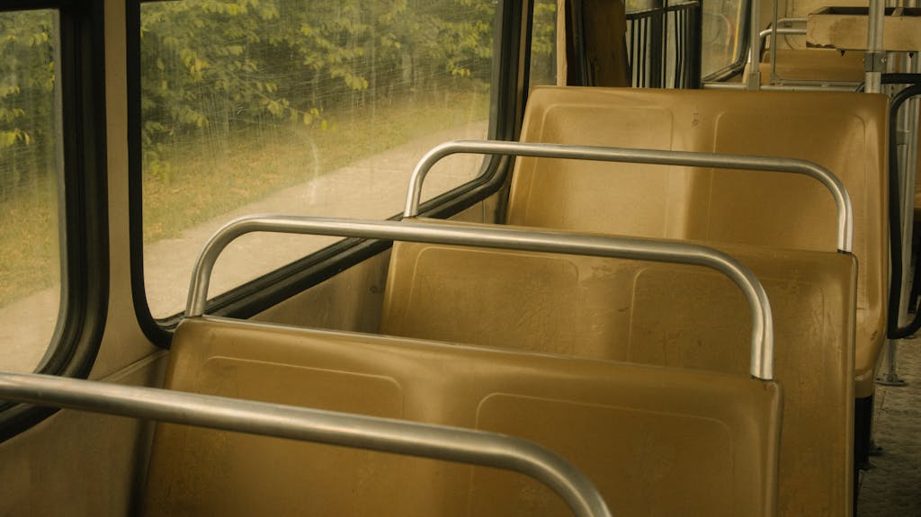 Explore the tranquil and vintage interior of an empty public bus with rows of seats.